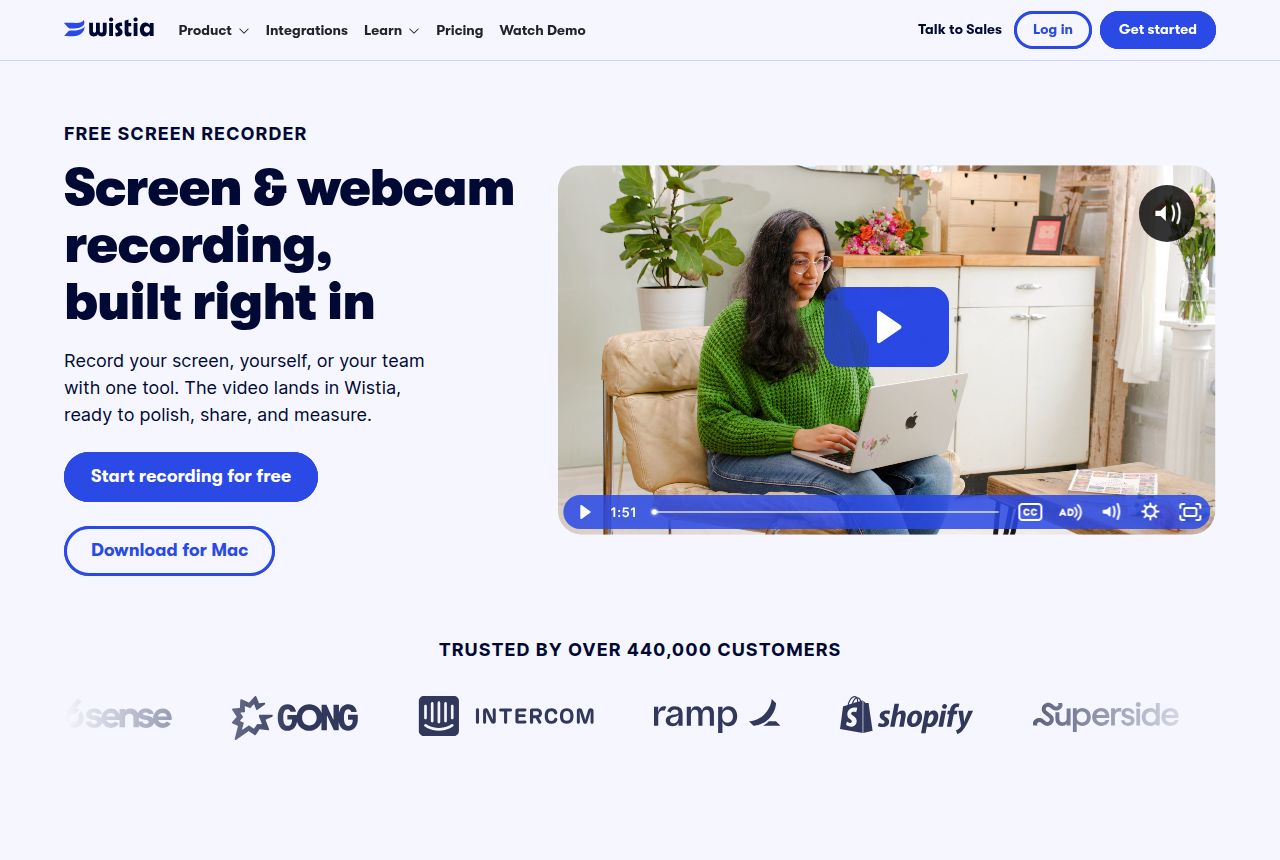 Wistia product page headed Screen and webcam recording, built right in, with a play button over a person in a green sweater using a laptop.